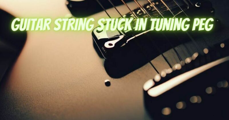 Guitar string stuck in tuning peg