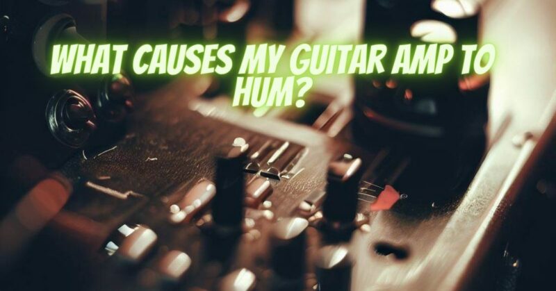 What causes my guitar amp to hum?